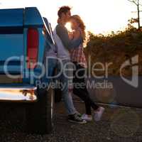 Off road romance. Shot of an affectionate young couple on a roadtrip.