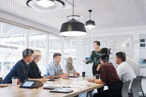 One dynamic team doing business. Shot of a group of businesspeople having a meeting in a modern office.