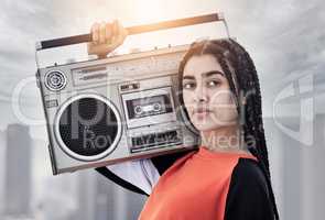 Im about that boombox life. Cropped portrait of an attractive young female dancer standing with her boombox on a rooftop against a stormy backdrop.