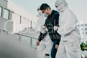 Follow us for a Covid-19 test. Shot of a young man getting taken away by healthcare workers in hazmat suits during an outbreak.