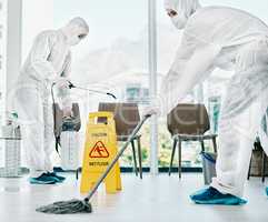 Control corona and keep it clean. Shot of healthcare workers wearing hazmat suits and sanitising a room during an outbreak.