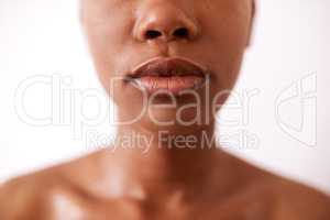 You have to take care of your whole body including your lips. Closeup shot of a beautiful young woman posing with glossy lips against a white background.