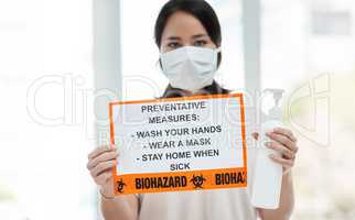 Its important to know how to protect yourself from coronavirus. Shot of a woman holding up a sign with a list of COVID-19 prevention measures.