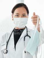 This is our advice to limit the spread of coronavirus. Cropped shot of a medical practitioner holding up a face mask.