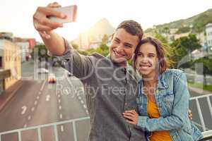 Sentimental selfies. Shot of a happy young couple taking a selfie together in the city.