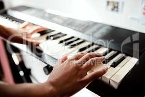 I may not have the words but my piano will. Cropped shot of a woman playing music on a keyboard at home.