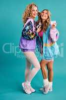 We love everything about the 80s. Studio shot of two beautiful young women styled in 80s clothing.