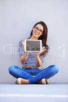 Your site is now live. Full-length shot of an attractive young woman holding up a digital tablet with a blank screen.