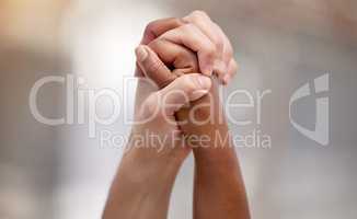 Bonded by a heartfelt cause. Shot of two people united and holding hands at a protest.