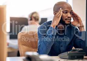 Sales can be a stressful too. Shot of a young call centre agent looking stressed out while working on a computer in an office.
