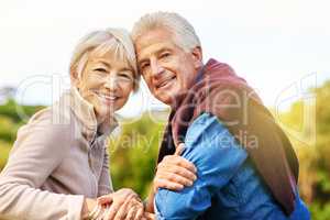 True love is infinite. Portrait of a happy senior couple sitting on a park bench.