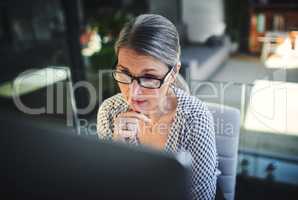 Advanced technology for enhanced productivity. Shot of a mature businesswoman using a computer in a modern office.