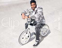 Just me and my BMX. Full length portrait of a handsome young man riding his BMX outside.