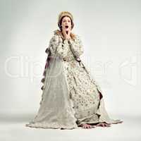 The peasants are revolting. Studio shot of young queen gasping in surprise.