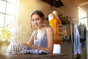 Keep calm and design on. A young designer making a garment in her workplace.