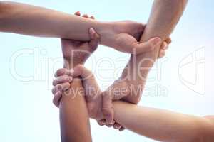 No discrimination between our team. Shot of a group of diverse people with their arms interlinked.