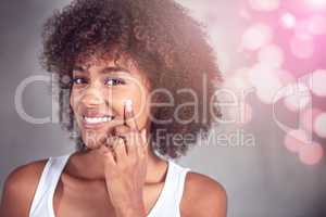 Taking care of my skin. Cropped portrait of a young woman moisturizing her face in the bathroom.