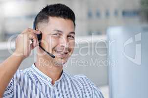 Yes we should be able to handle this no problem. Shot of a young businessman working in a call center office helping a client.