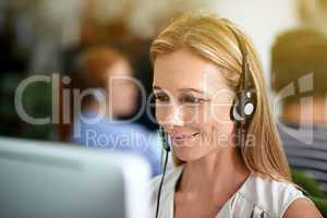 Directing calls with a smile. Cropped shot of a young businesswoman wearing a headset.