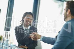 Im glad to be on board with this project. Cropped shot of businesspeople shaking hands in an office.