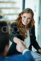 Shes become another valuable member of the team. Cropped shot of businesspeople shaking hands in an office.