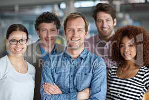 Diverse minds for strong business. A diverse group of creative professionals looking positively at the camera.