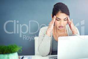 Dont let your job suck the happiness out of you. Shot of a businesswoman sitting with her hands on her head.