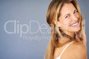 There are so many beautiful reasons to be happy. Studio shot of an attractive young woman posing against a gray background.