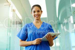Shell help you protect your greatest asset your health. Portrait of a young nurse using a tablet while standing inside a clinic.