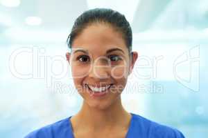 Here to help you heal. Portrait of a confident young nurse smiling in the clinic.