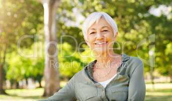 The golden years couldnt have turned out better. Cropped portrait of a happy senior woman sitting alone at the park.