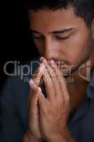 Faith will find the answer. Cropped shot of a young man holding his hands together in prayer.