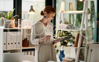 The smart way to stay organised. Shot of a young businesswoman using a digital tablet in a modern office.