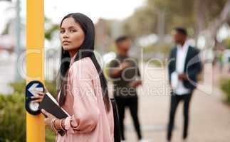 Determination determines your direction. Shot of a young businesswoman about to cross a city street.