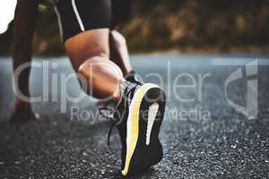 Nothing can stop me now. Low angle shot of a man out exercising on a tarmac road.