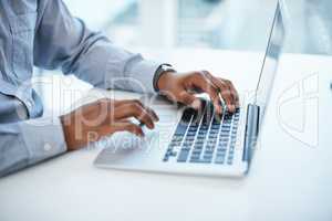 A good fibre connection produces good work. Shot of a businessman using a computer in a modern office.