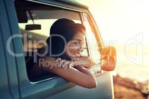 Slowing it down this summer. Shot of a young woman enjoying a relaxing roadtrip.