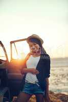 Summer isnt complete without a memorable road trip. Shot of a young woman enjoying a relaxing roadtrip.