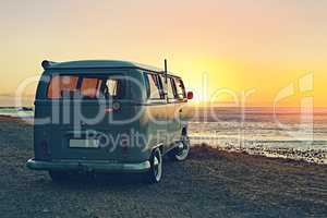 Adventures on the horizon. Shot of a minivan parked at the beach at sunset.