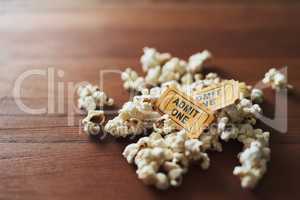 Memories of a great night out. Shot of a pile of popcorn and two movie tickets.