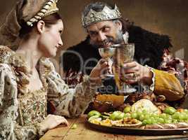 Maybe a full goblet will cheer you up mlady. A mature king feasting alone in a banquet hall.