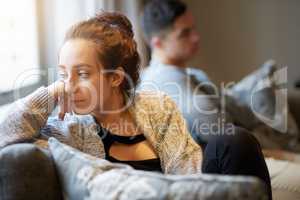 Going through a rough patch. Shot of a young woman looking despondent after a fight with her boyfriend.