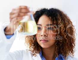Searching for a solution. Cropped shot of a young female scientist conducting an experiment in the lab.