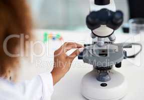 Time to inspect this sample. Cropped shot of a young female scientist analysing a sample in the lab.