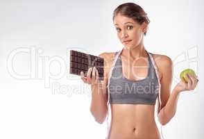 Shes a lover of chocolate. Studio shot of an attractive young woman being tempted by something sweet.