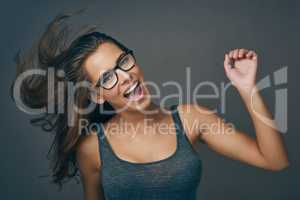 Let go and be who you are. Studio shot of an attractive young woman wearing glasses.