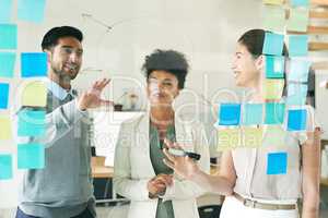 Brainstorming brilliant ideas. Shot of a group of young colleagues having a brainstorming session at work.