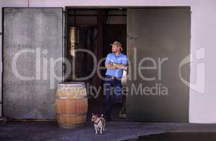 You know where to find the best wines. Shot of a male sommelier standing in the doorway of his distillery.