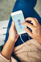 Waiting in the bus station. High angle shot of an unrecognizable young woman using her smartphone while sitting in a bus station.