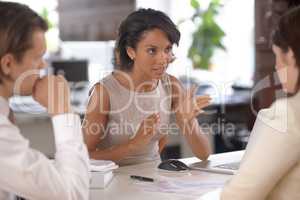 Explaining the important aspects. Attractive female business supervisor in discussion with some coworkers.